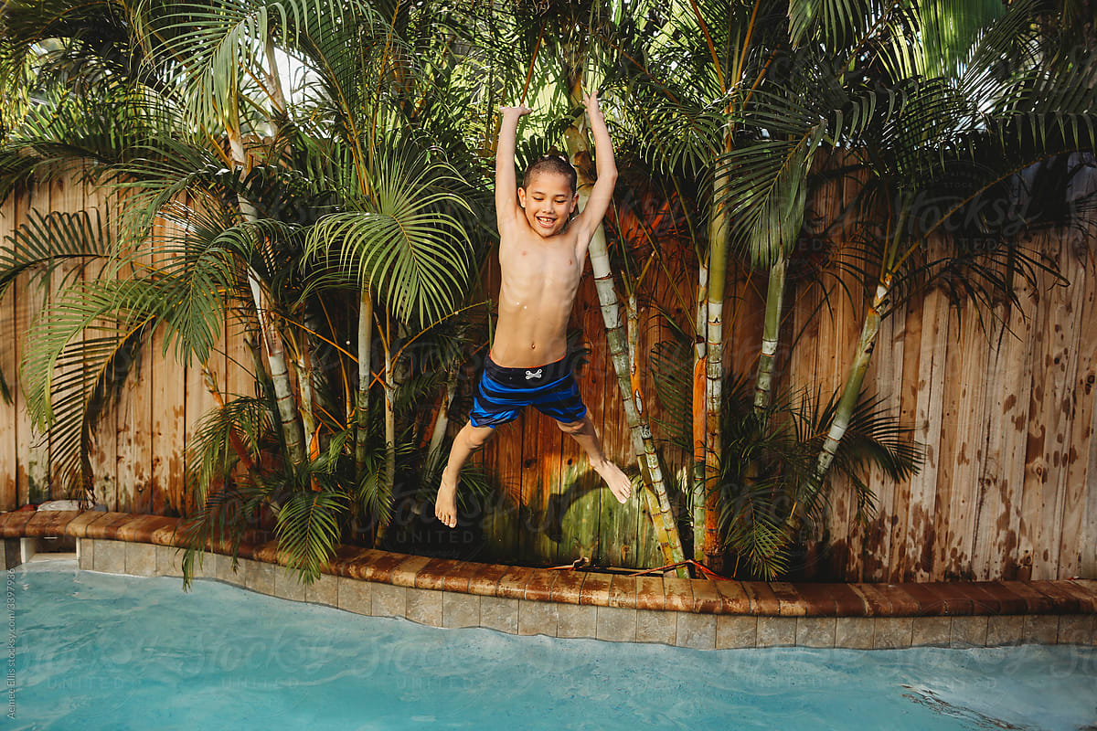 A boy jumping in a pool