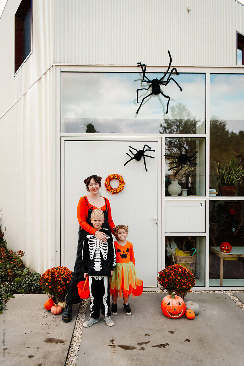 House with owners in halloween outfit and halloween decorations