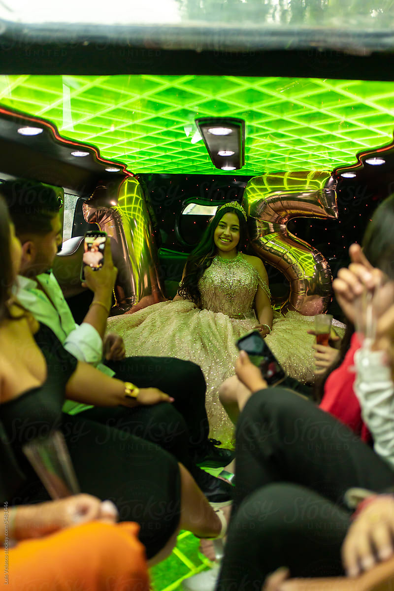 Quinceanera With Friends On Her 15th Birthday Party In A Limousine.