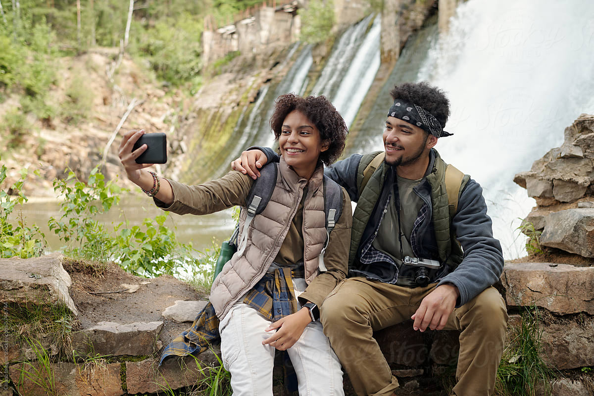 Man And Woman Taking Selfies While Travelling