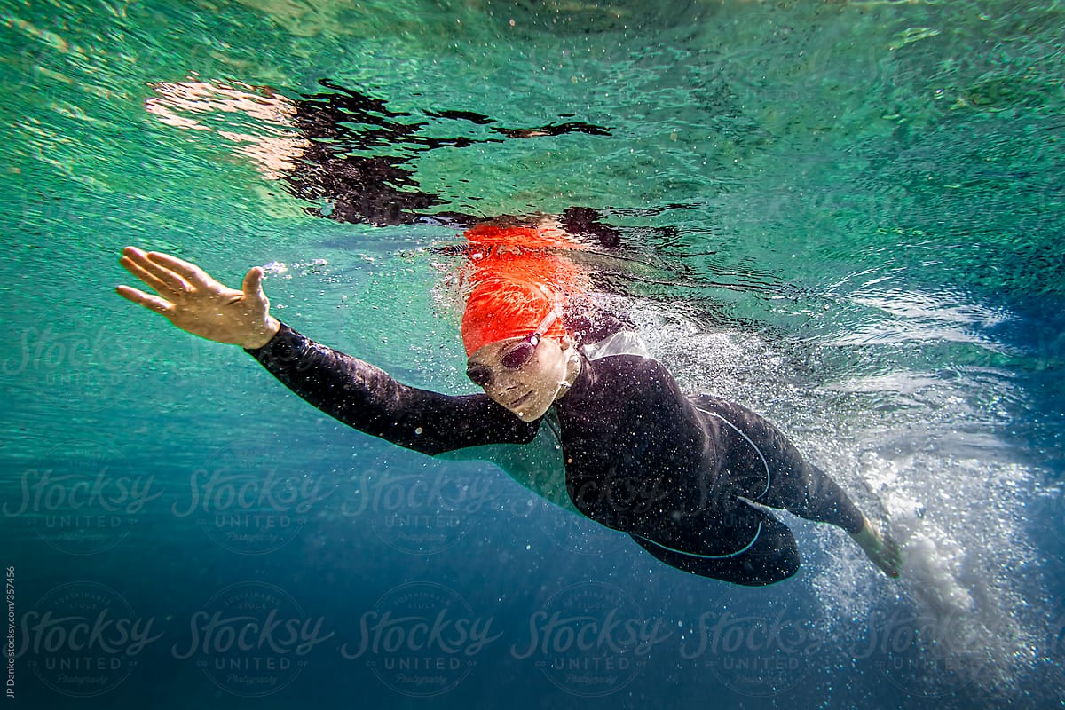 Underwater Female Triathlon Athlete In Swim Stage In Lake With Wet Suit By Stocksy Contributor