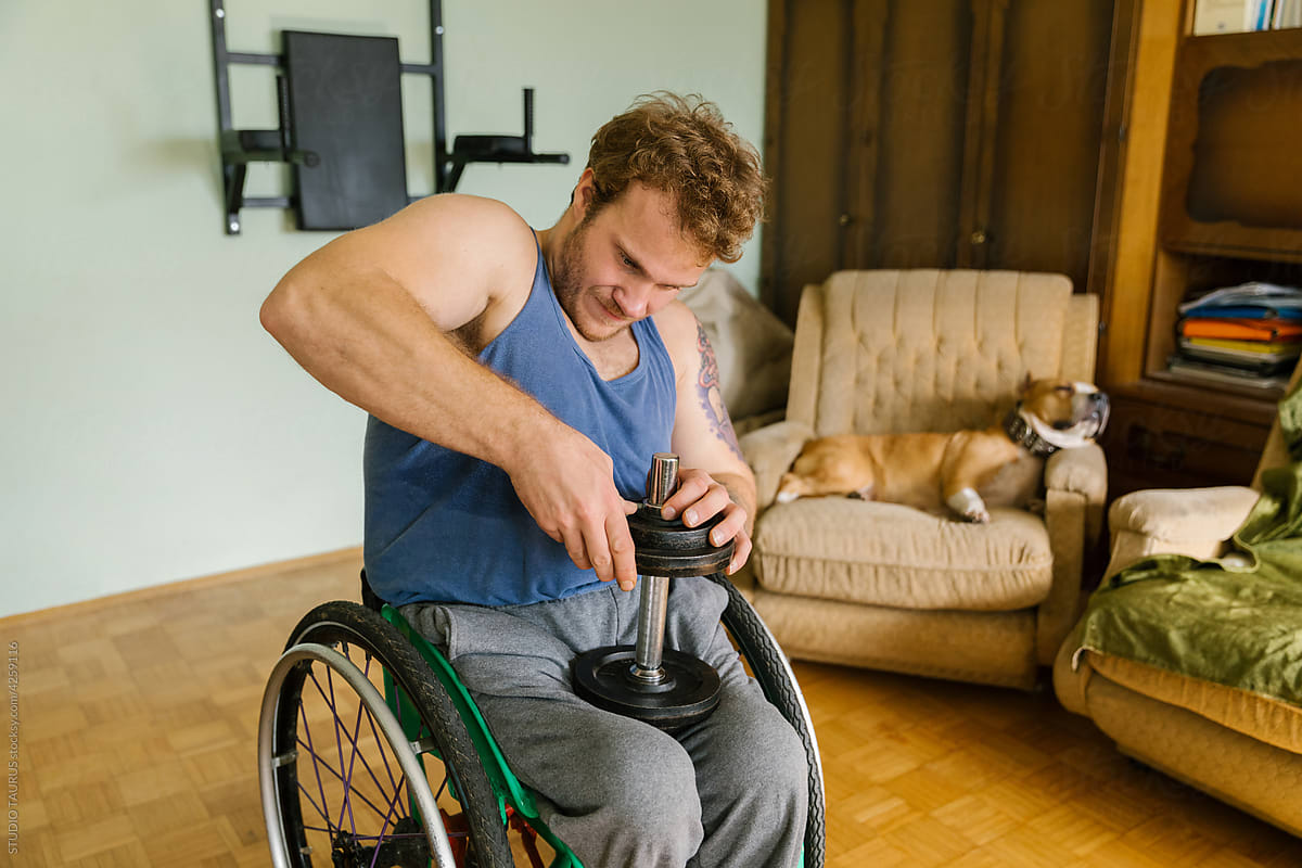 Physically Disabled Man With A Weight In His Lap