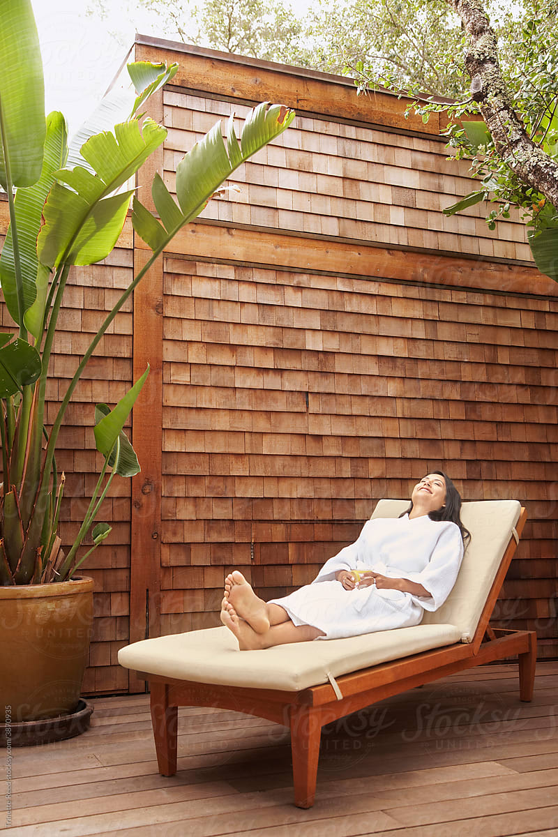 Woman relaxing at spa on lounger