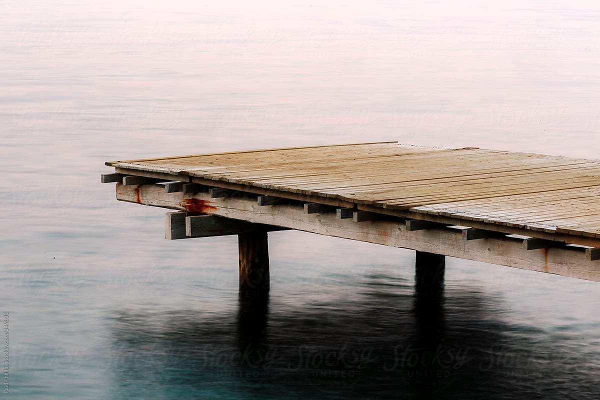 Small Fishing Pier In A Calm Sea At Dawn. by Stocksy Contributor Paul  Phillips - Stocksy