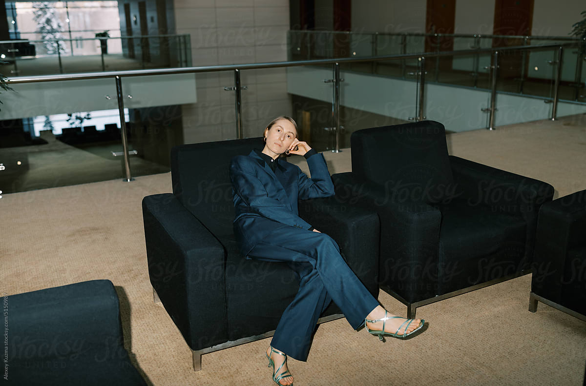 Androgyne woman wearing man classic suite  indoors
