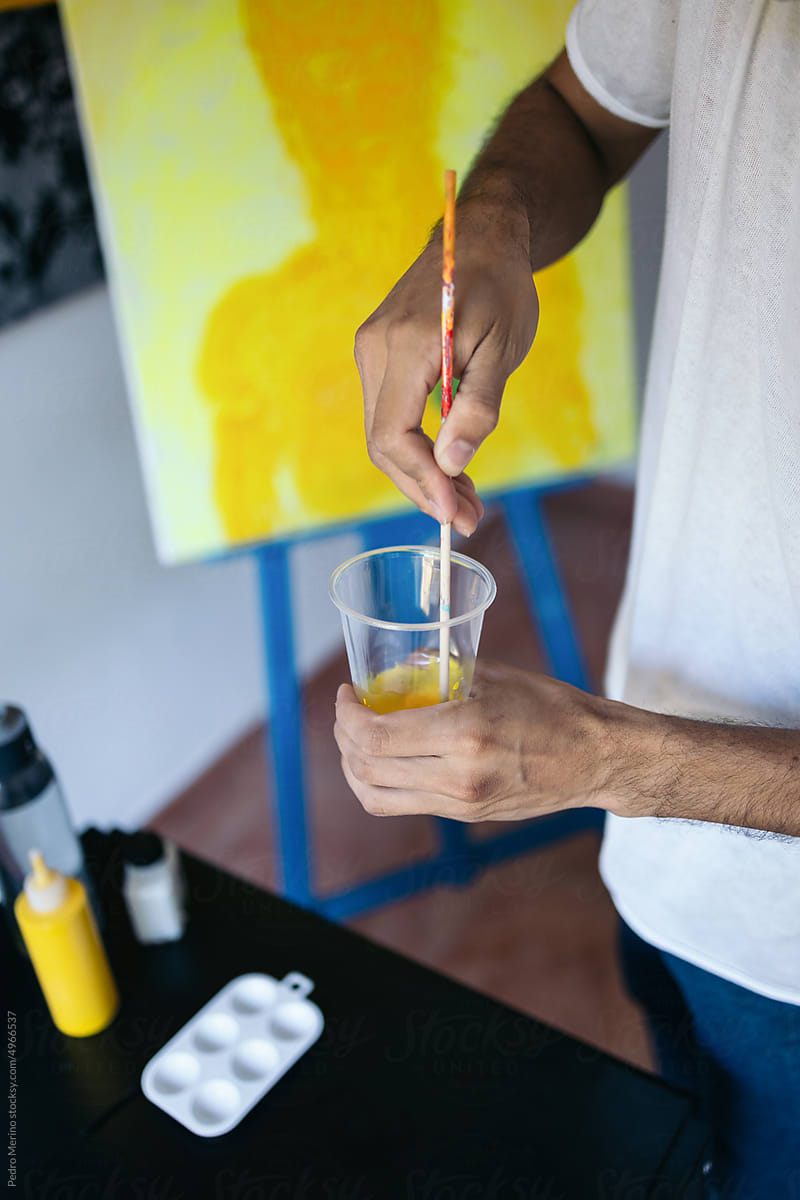 Artist preparing his materials to paint a picture on canvas