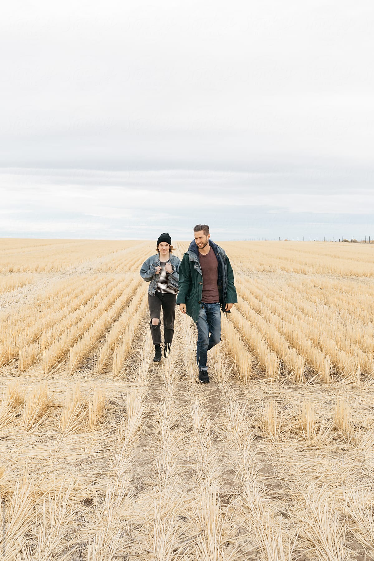 Couple walks through farm field oregon