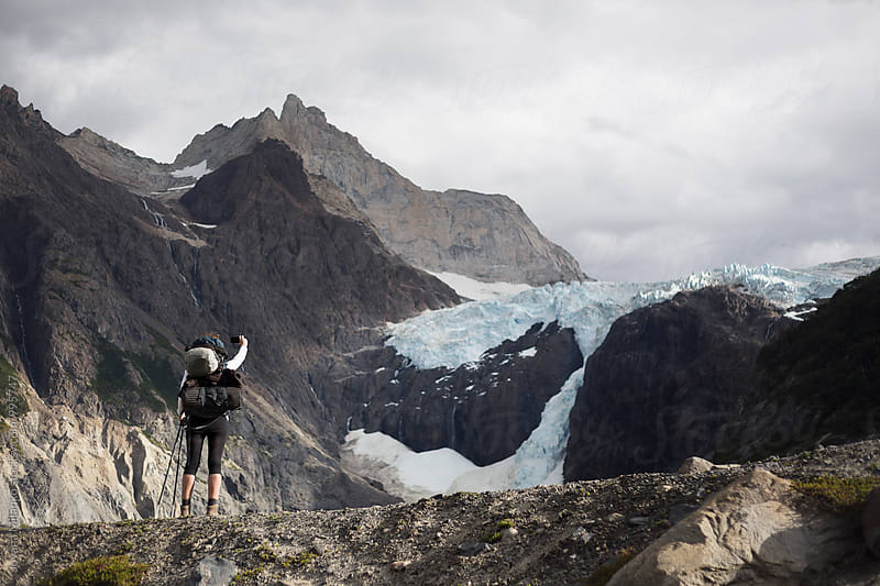 Female hiker taking a photo with her mobile phone  of a glacier in Torres Del Paine National Park in Chilean Patagonia