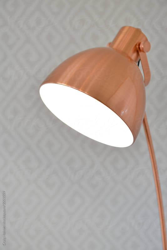 Rose gold colored lighting lamp in a home setting.
