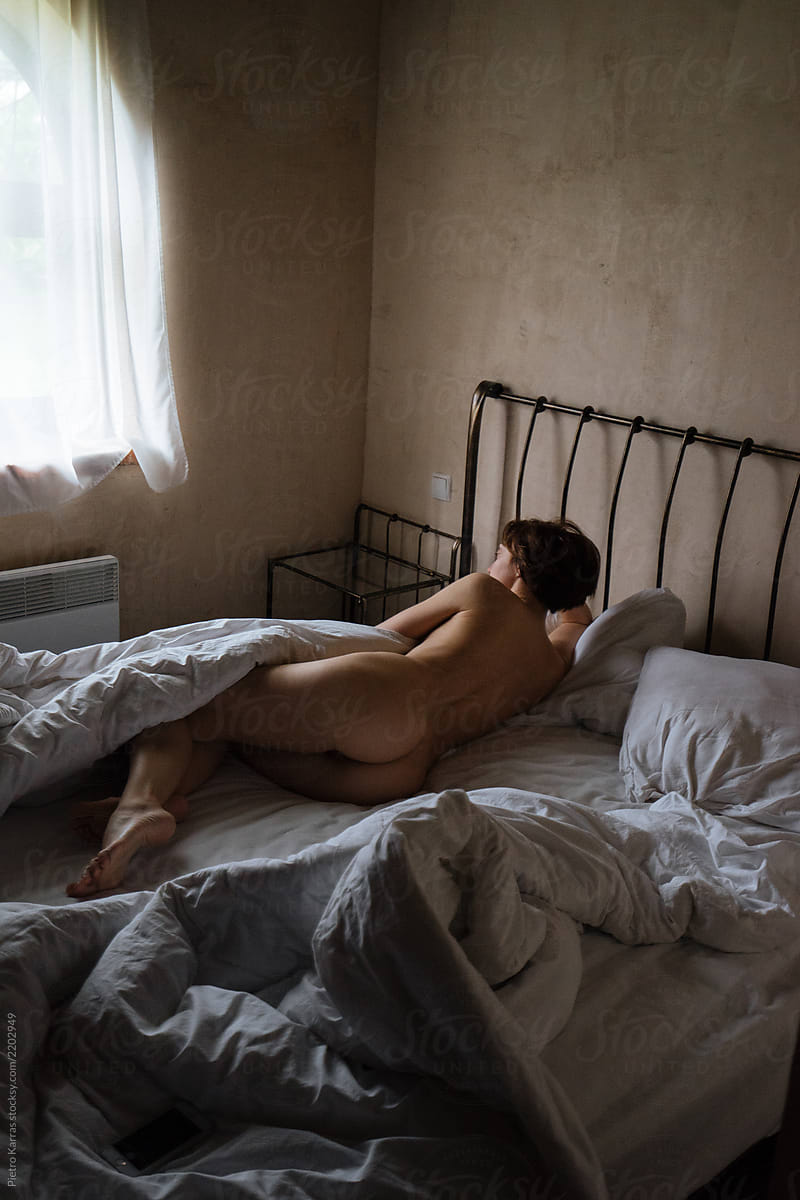 Nude woman in bedroom