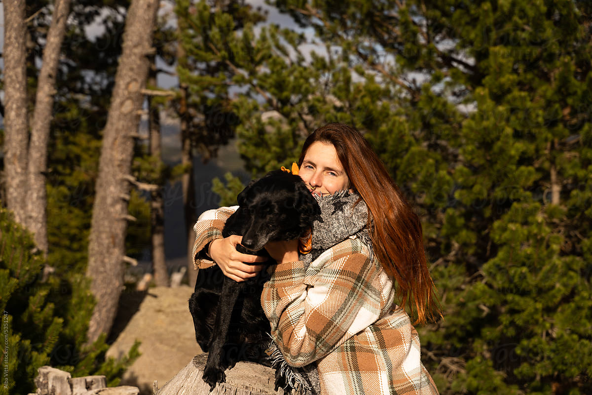 woman and dog in nature during holidays