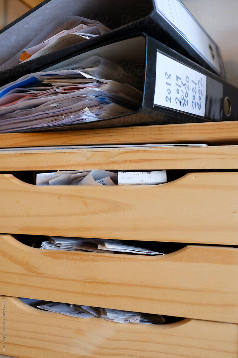 Business receipts in messy cabinet and folder