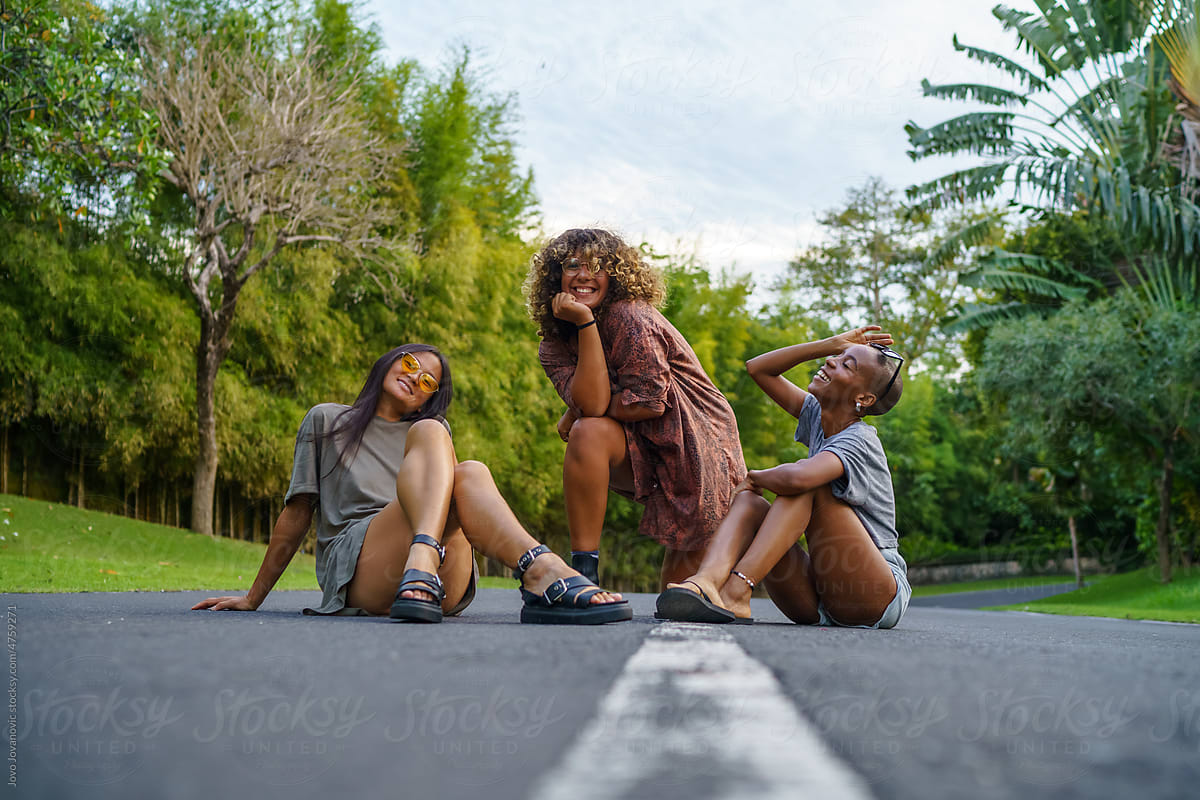 three young female friends pose together in the Studio. women dance  together. concept of friendship and communication Stock Photo | Adobe Stock