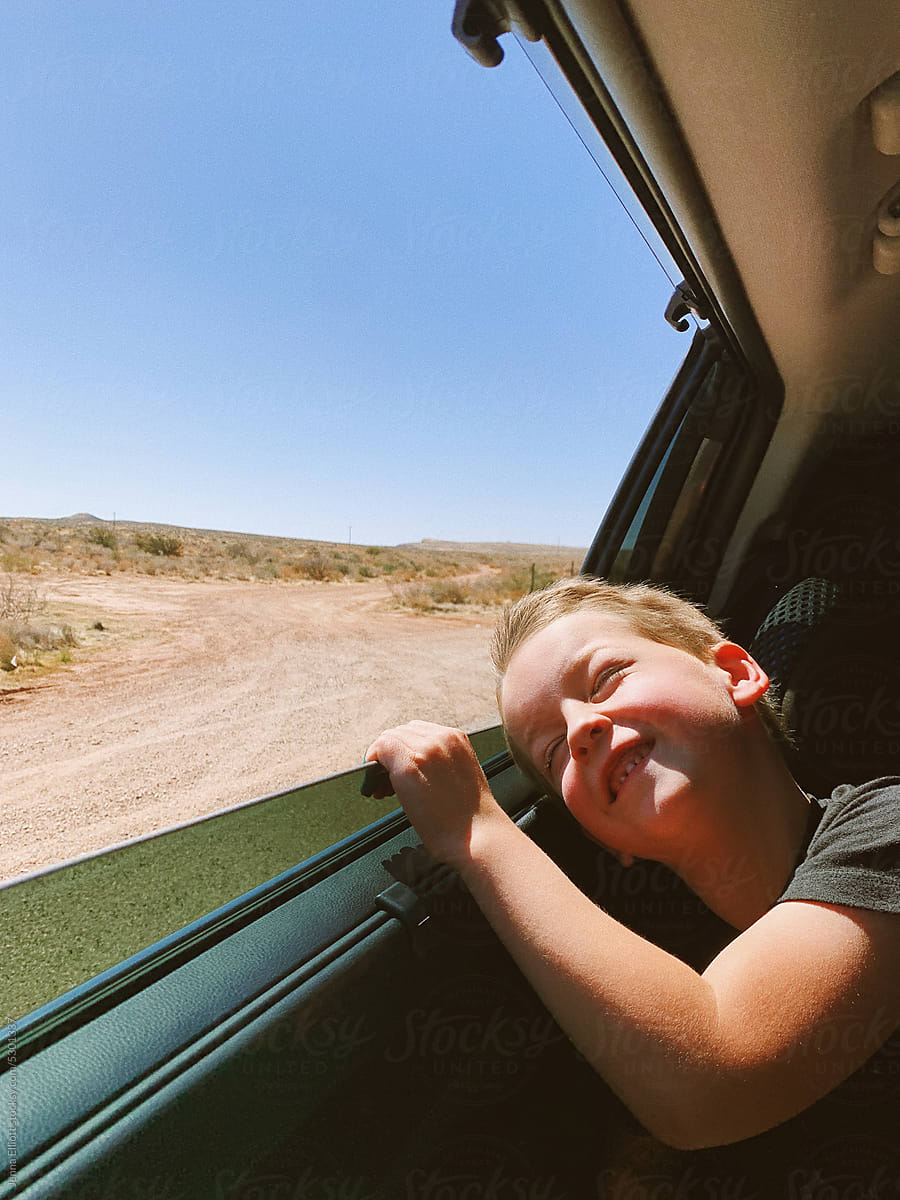Boy Enjoys Open Car Window