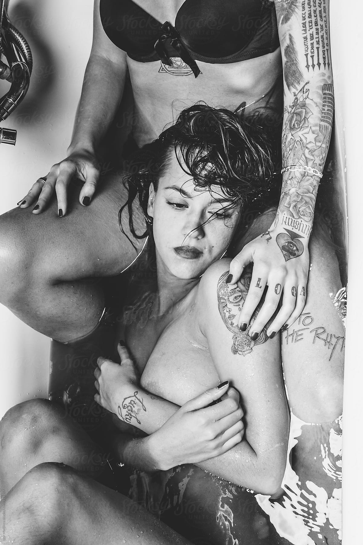 touch , two beautiful tattooed girl in a bathtub black and white