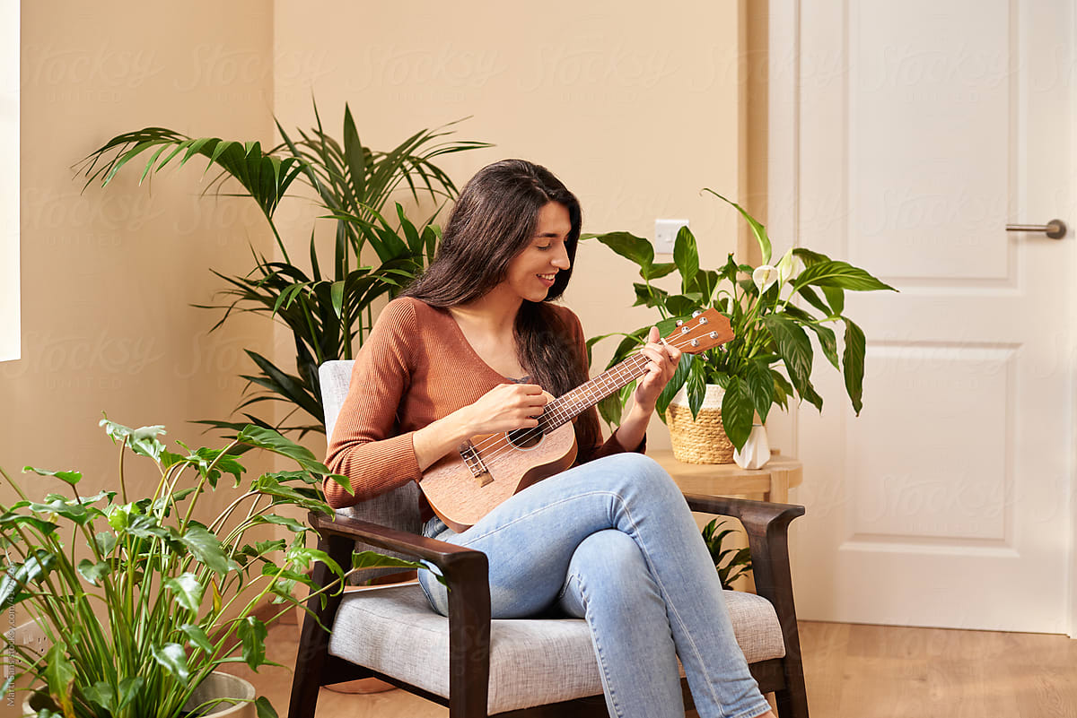Talented woman playing ukulele