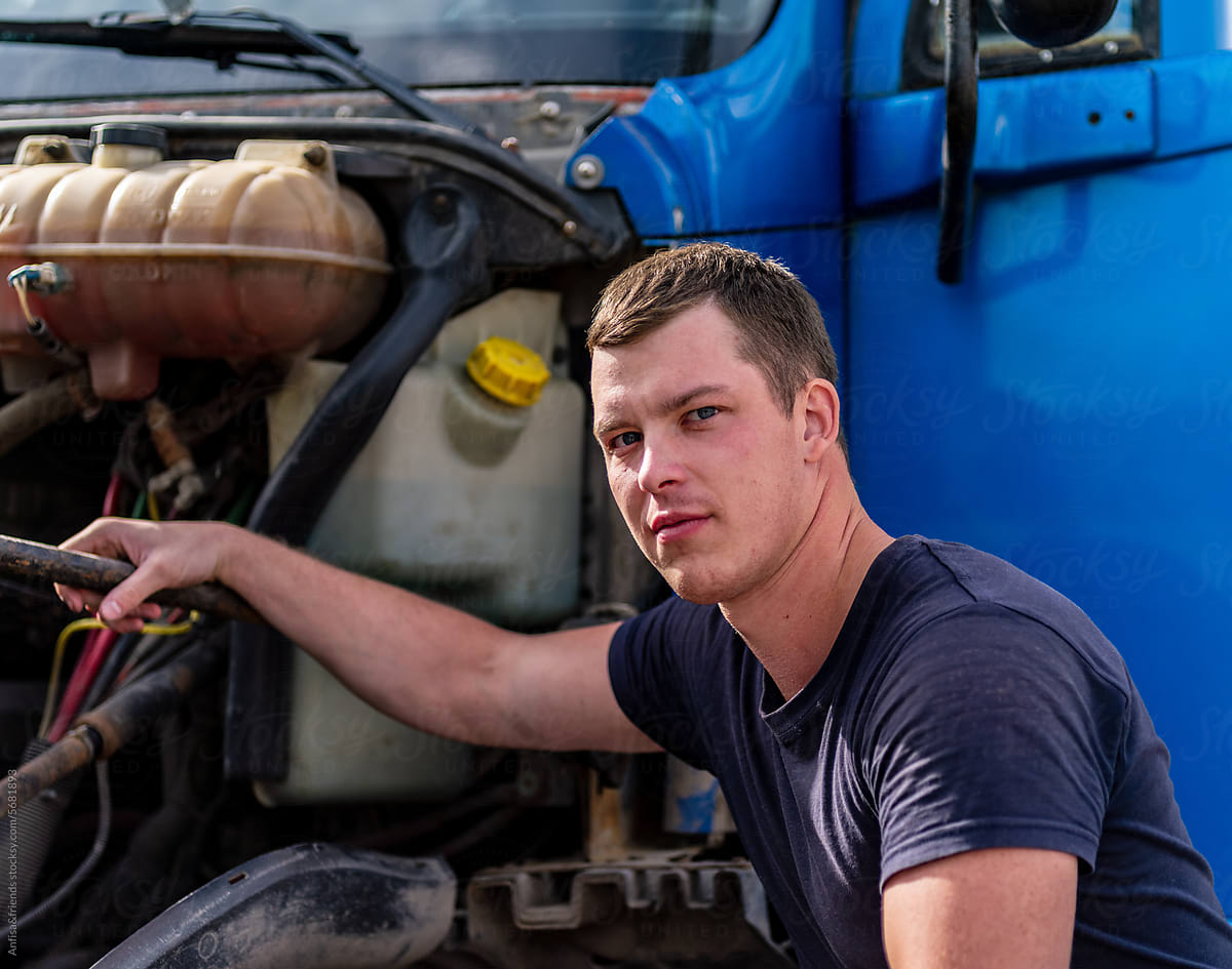 Truck Mechanic works with engine