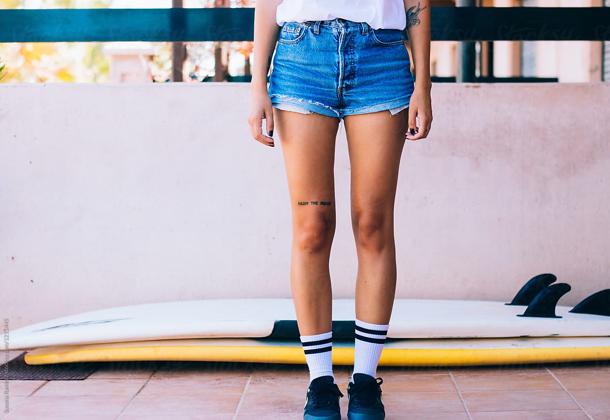 Woman legs with shorts, sneakers and 
