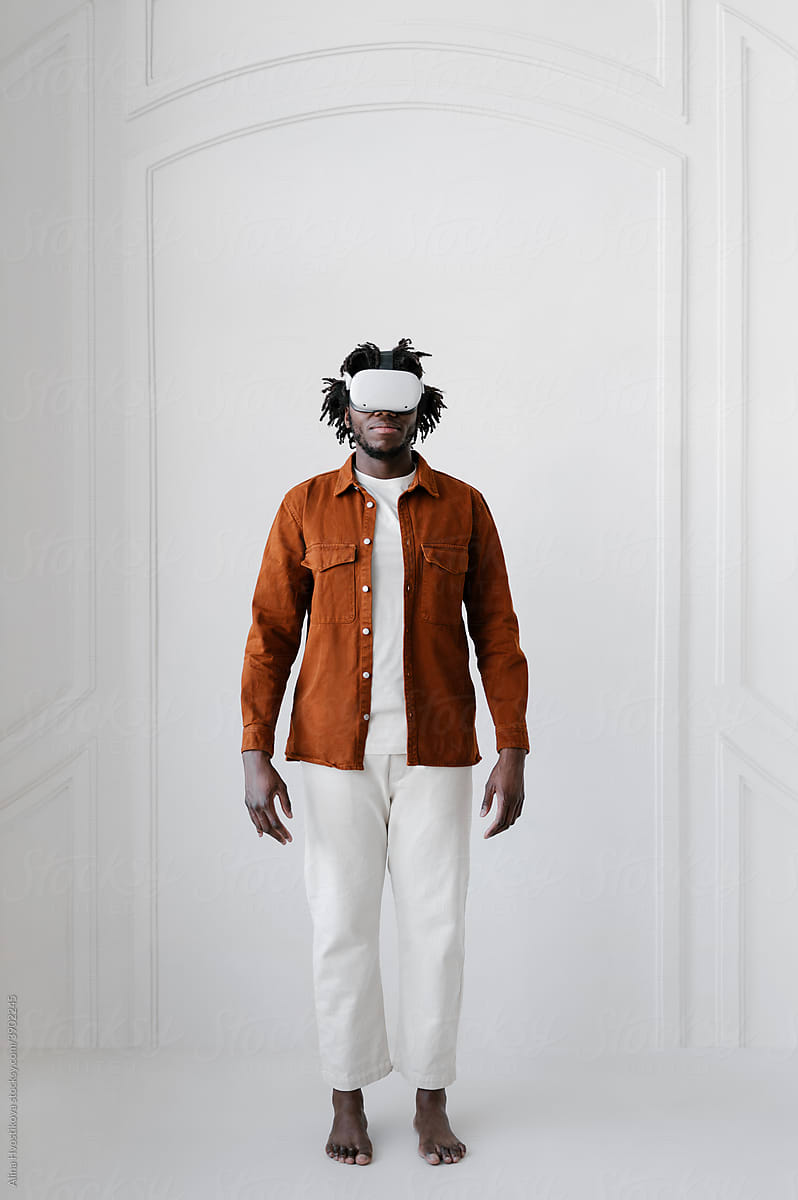 Black man in VR glasses at home