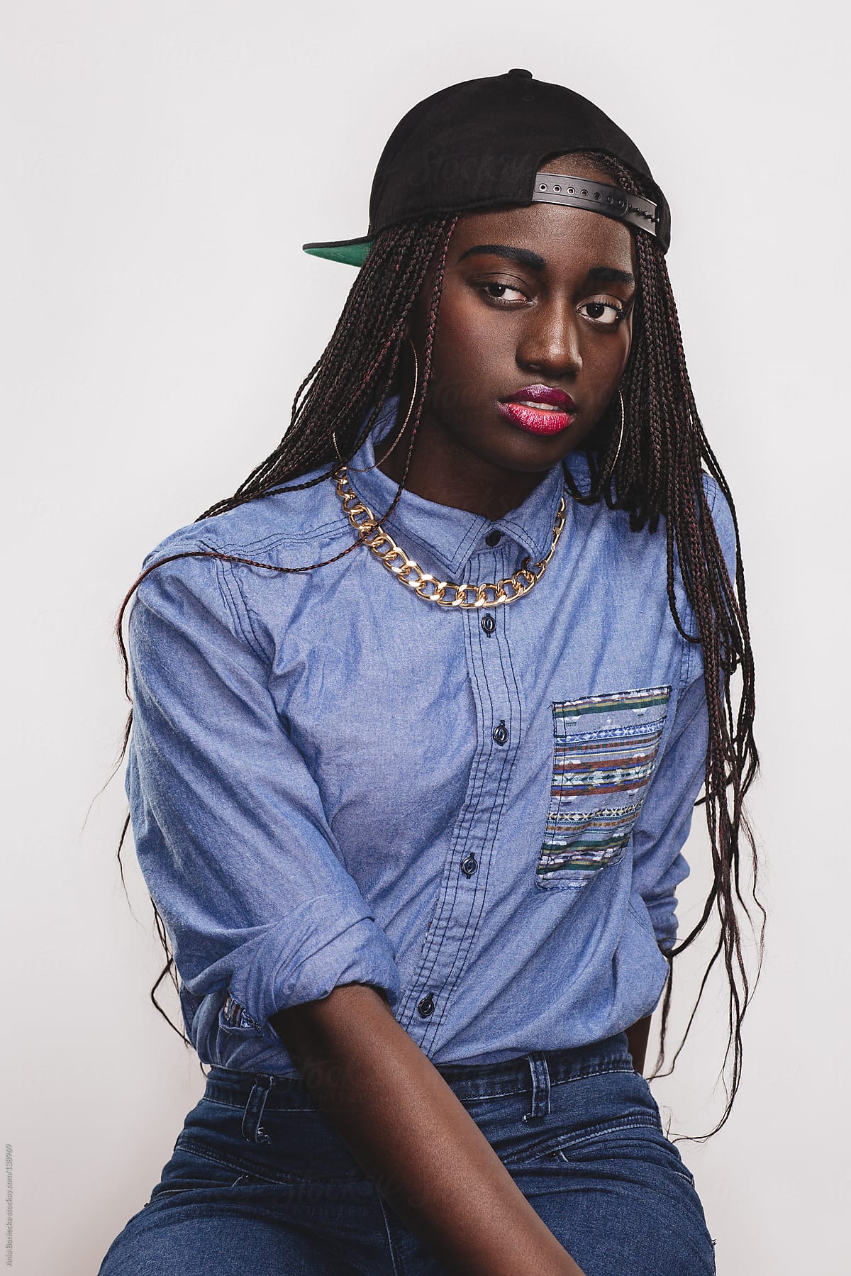 A Pretty Black Girl With Braids And A Backward Baseball Cap By Stocksy Contributor A Model