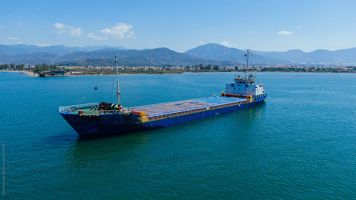 Floating barge in blue sea water