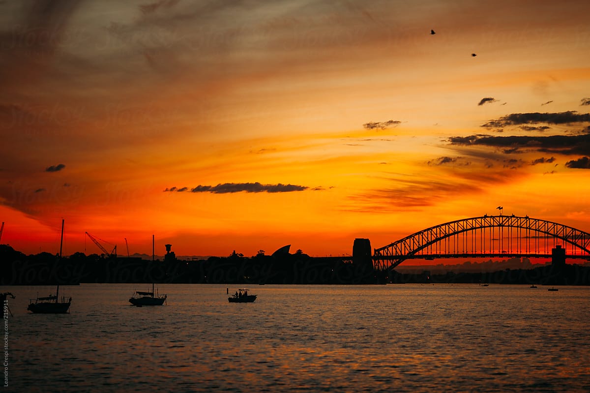 Harbor bridge in silhouette during sunset