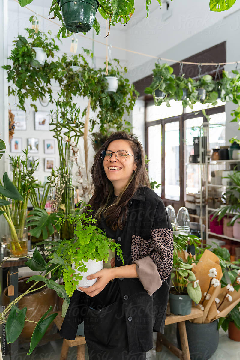 Young Woman Working In A Plants Store.