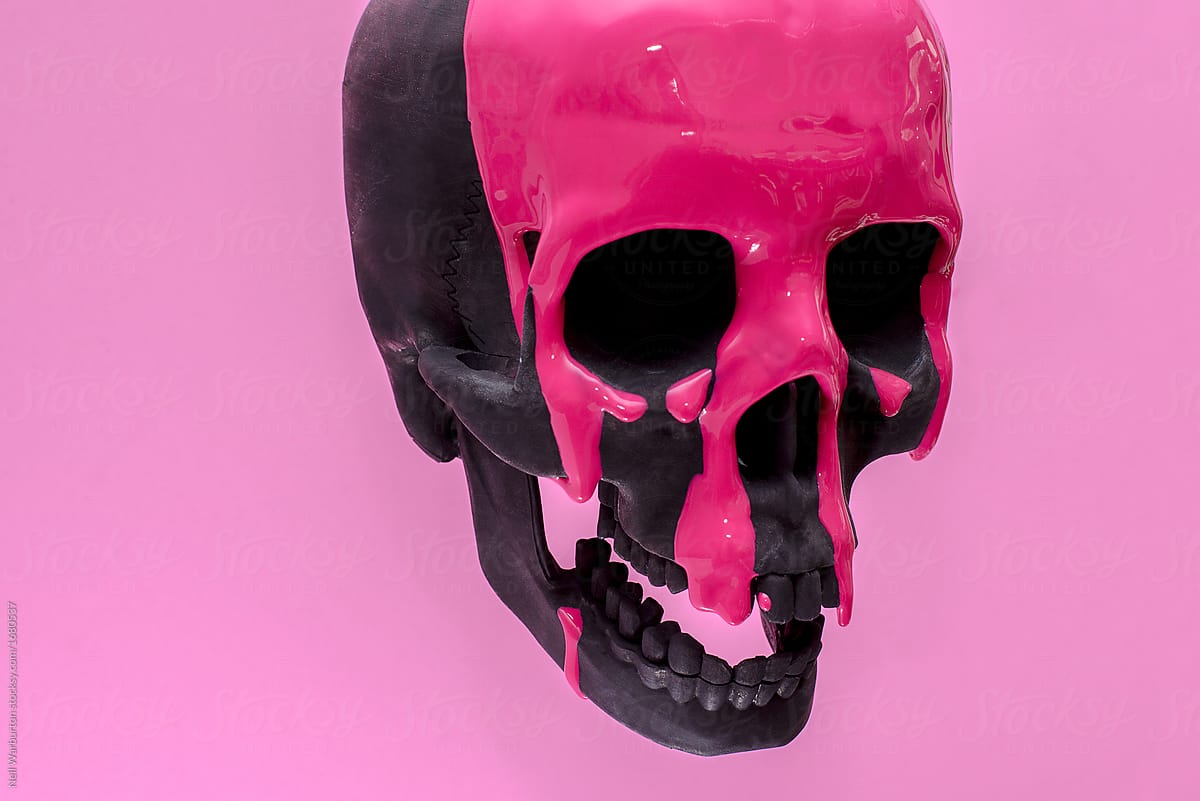 Black Skull With Pink Paint Running Down It Against A Pink
