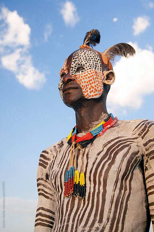 Portrait of a Karo tribesman with facial decoration in chalk imitating the spotted plumage of the guinea fowl, Lower Omo Valley, Ethiopia, Africa