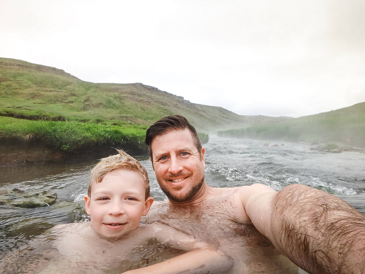 Dad and son enjoy moment together swimming in Iceland hot river