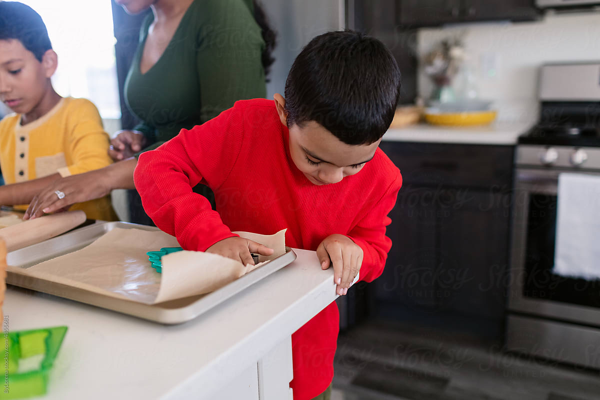 Young boy kneading cookies dough