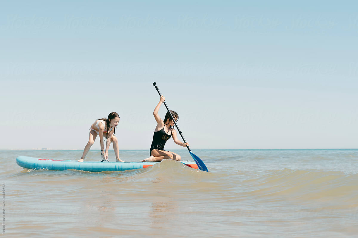 Girls paddling on the beach
