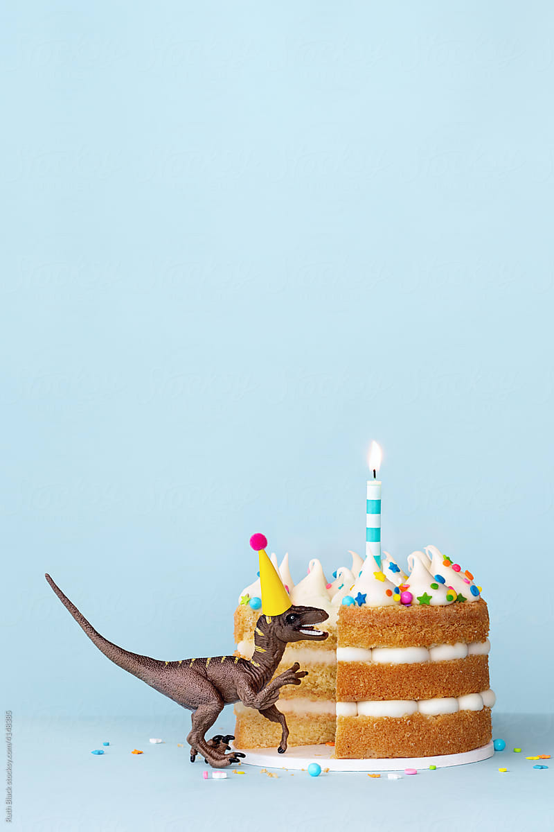 Dinosaur eating a birthday cake