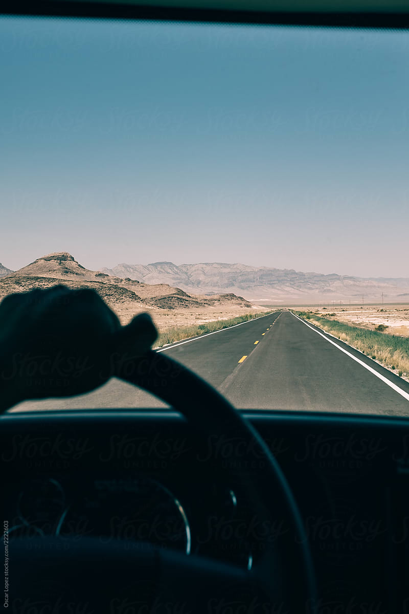 FIrst person view driving down a desert road