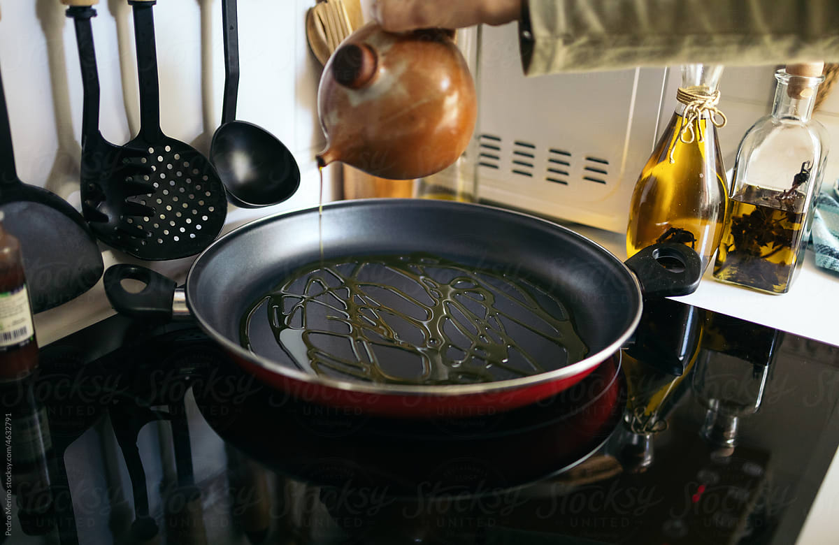 Woman cooking with olive oil