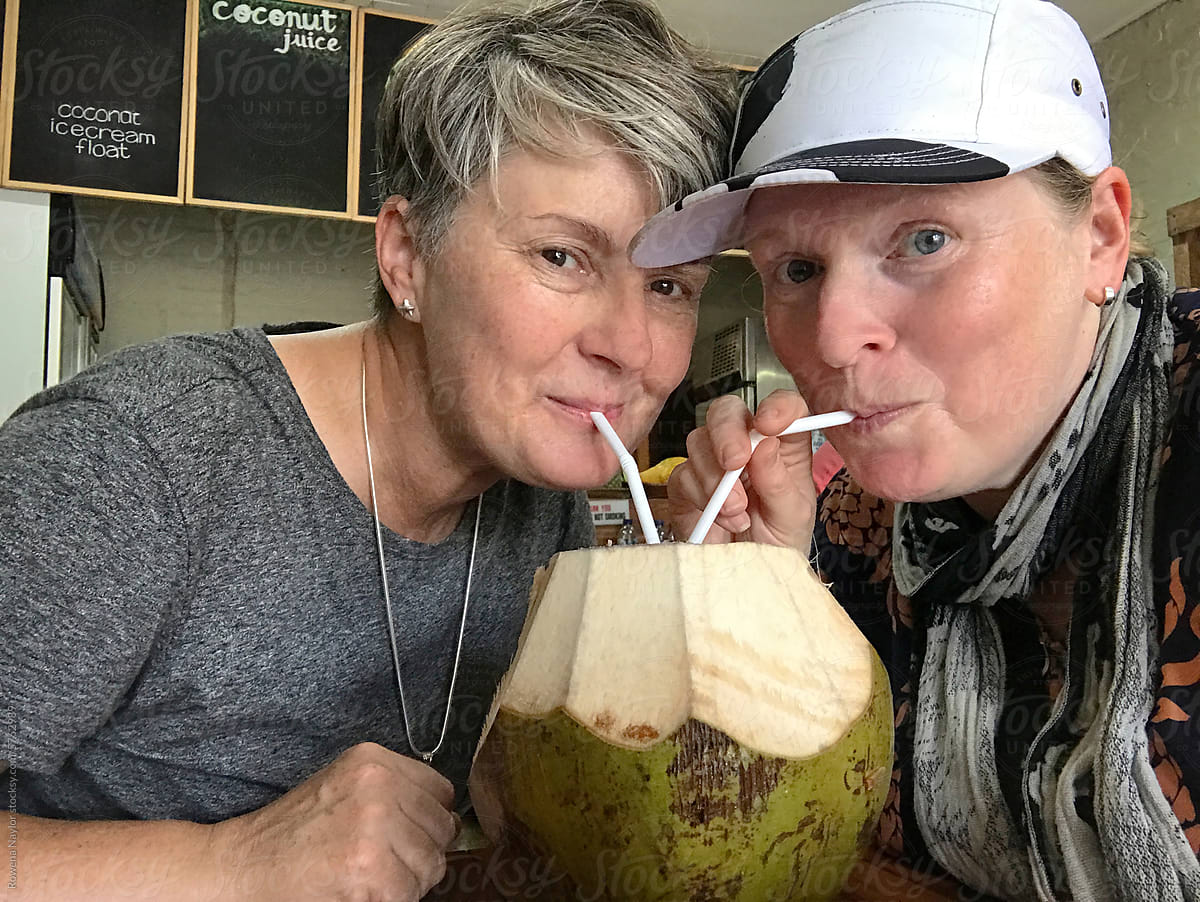 Couple enjoying young coconut drink on vacation in Bali, UGC