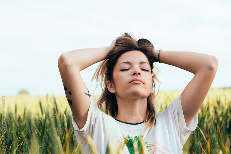 Relaxed woman touching her hair in the field