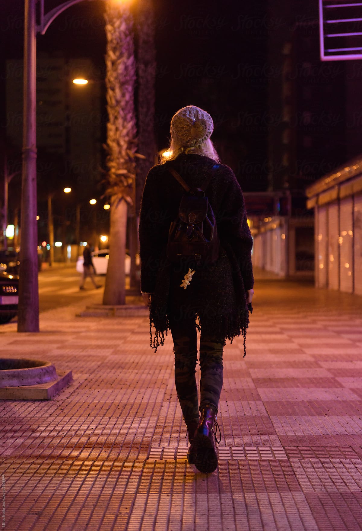 Woman walking on night street