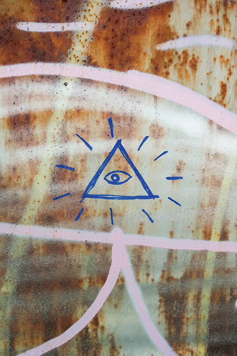 Triangle with eye symbol on the graffiti wall
