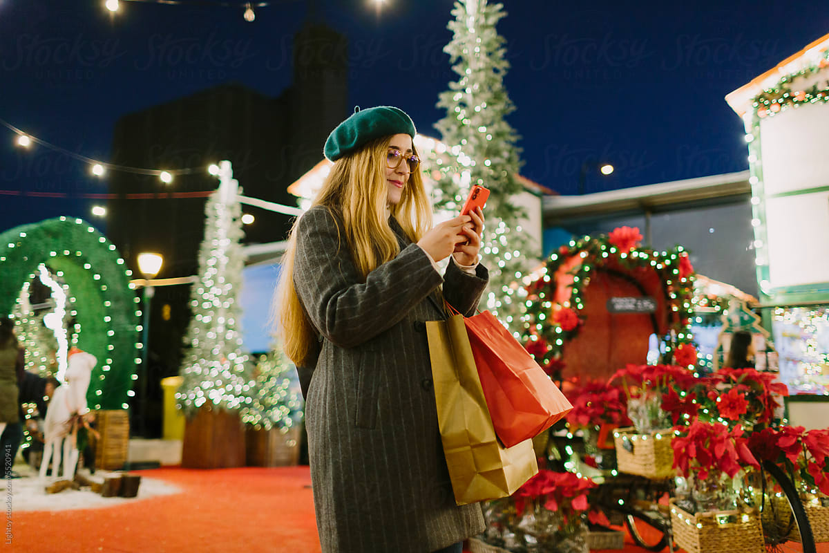A woman using a mobile phone at a Christmas Market