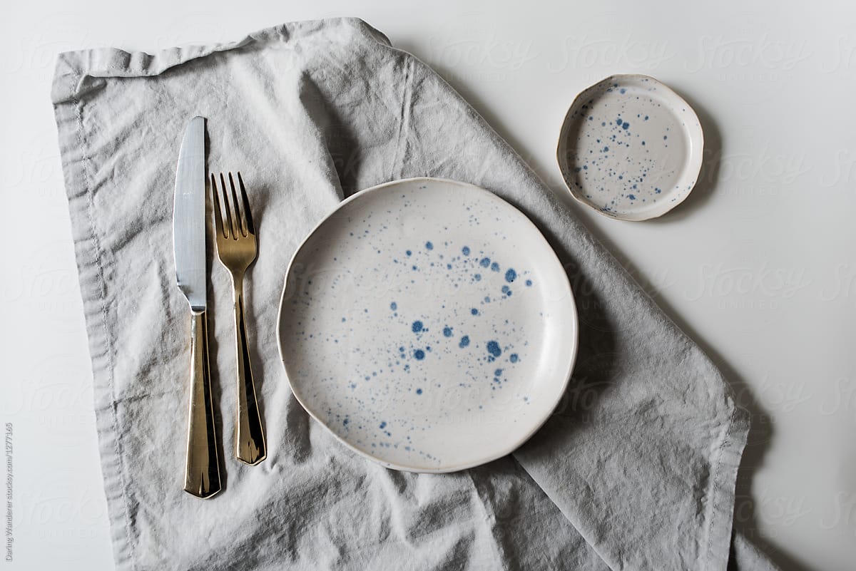 Neutral minimalist handmade plate styling on white and marble table