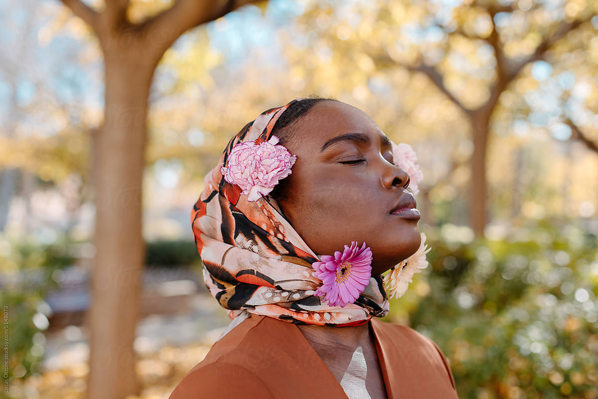 Black muslim woman with flowers on her hijab