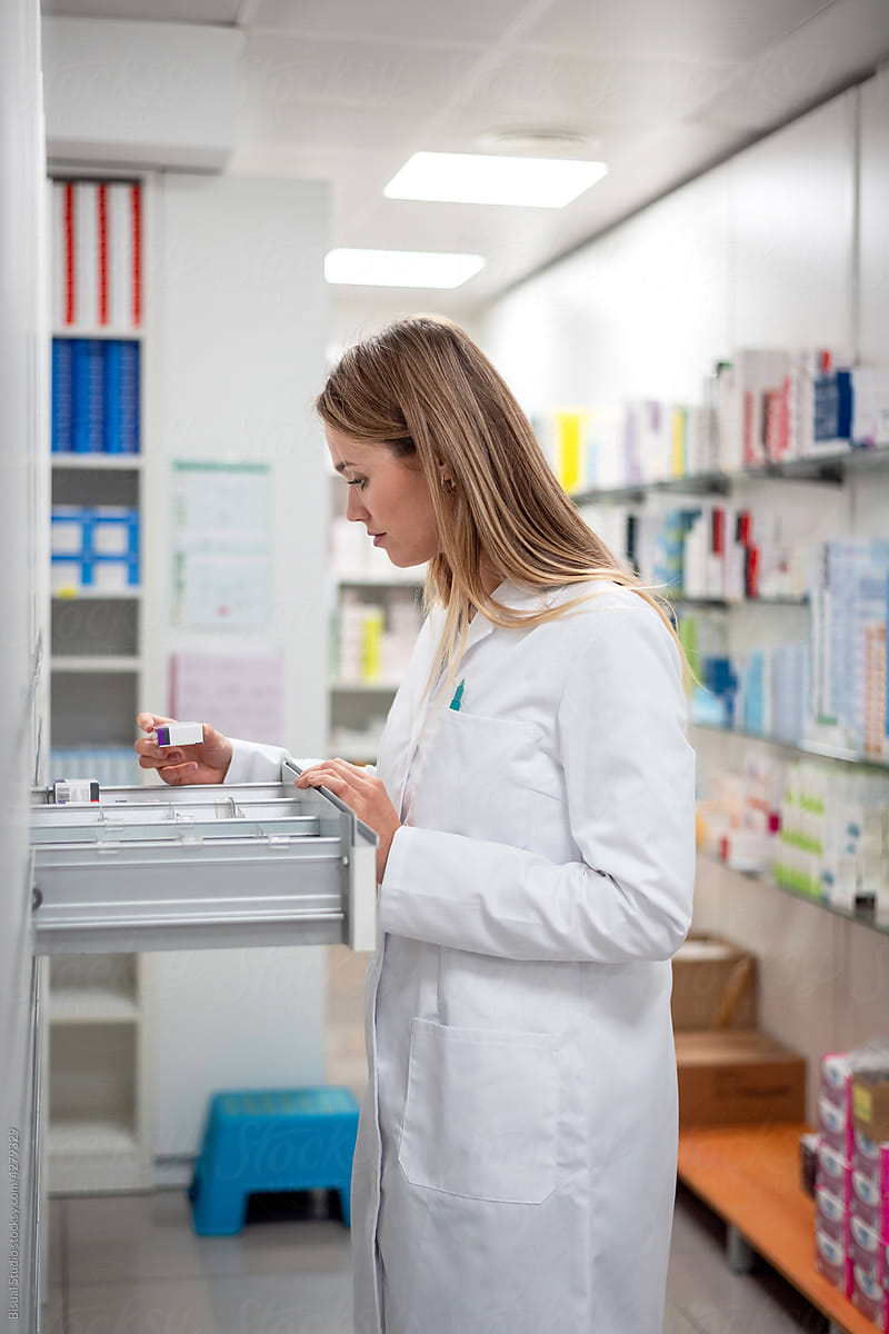 Pharmacist searching medicine in drawer
