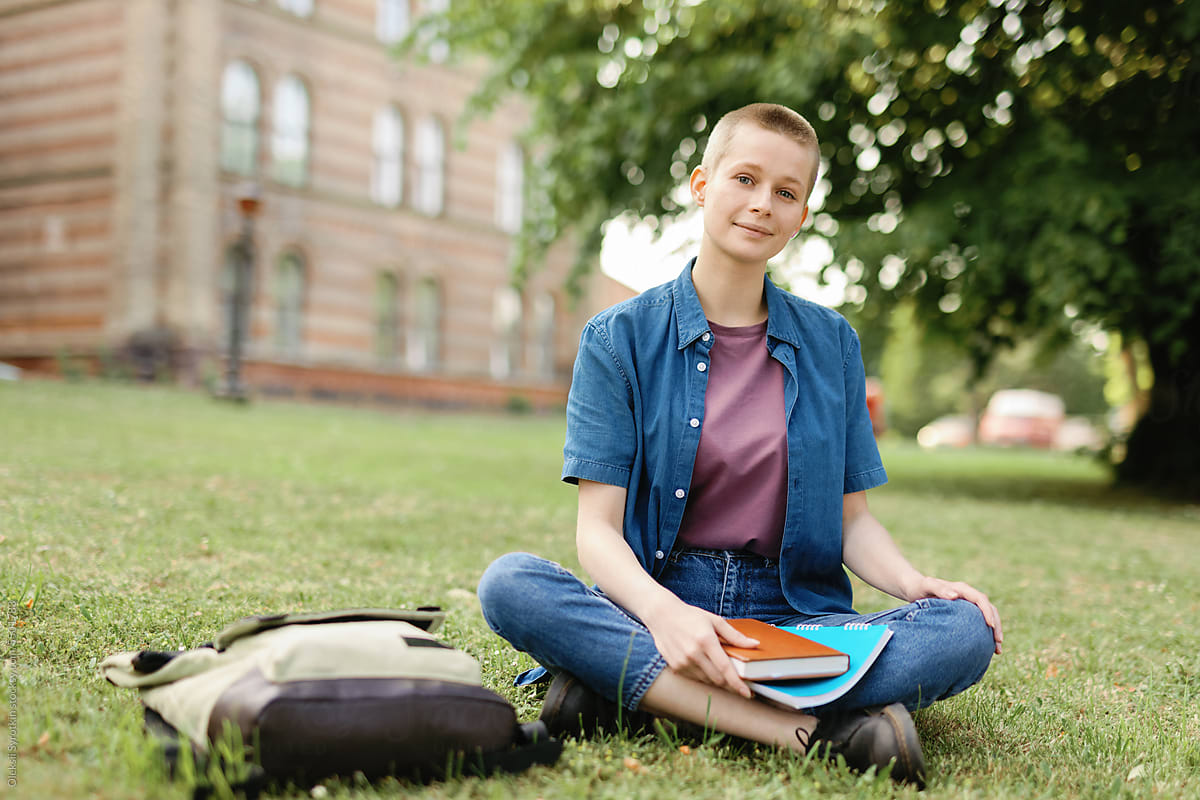 Green area androgynous student relaxation eye contact back to school
