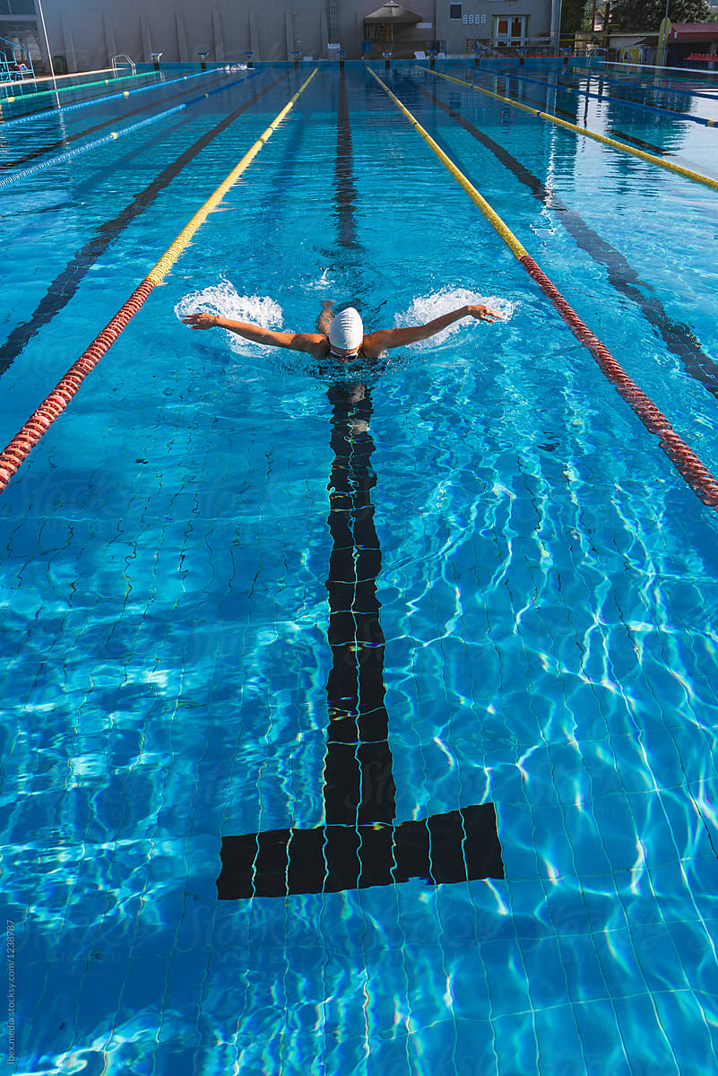Professional female swimmer training on butterfly swimming technique