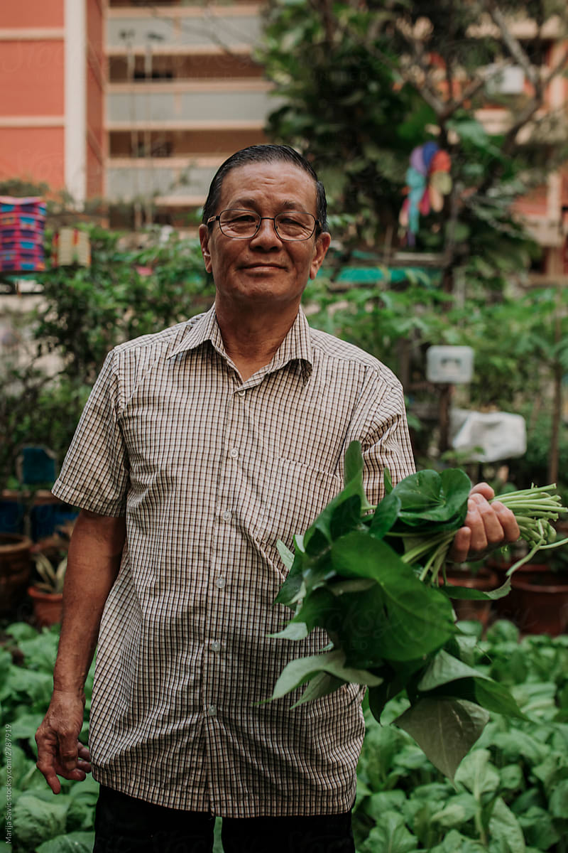 Old Chinese Man Working in Community Garden