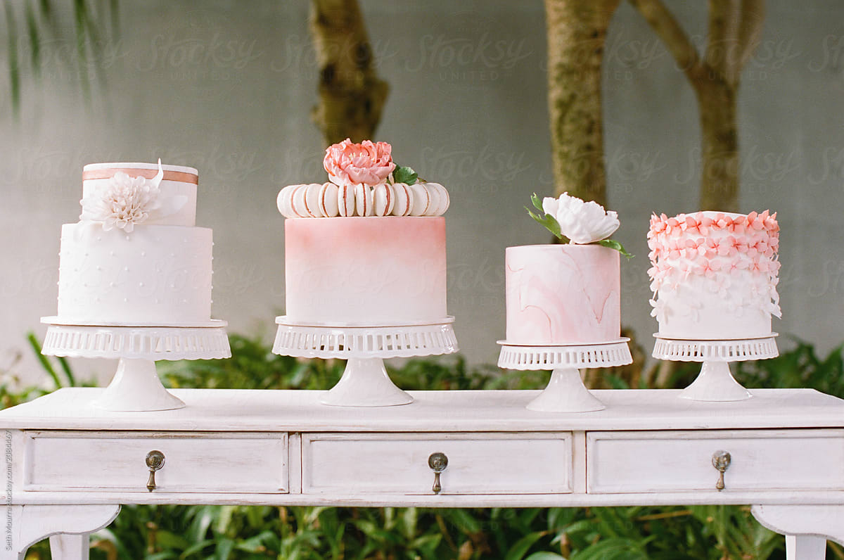 Four Pink and white decorated wedding cakes