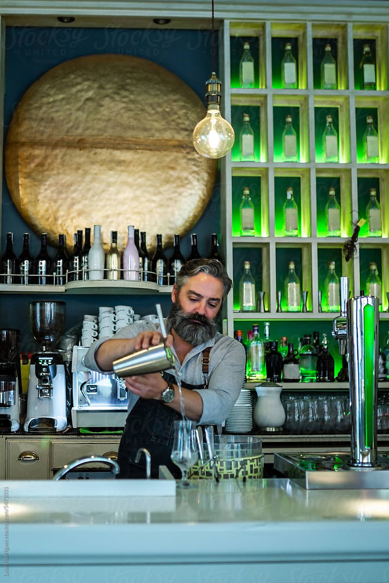 bartender preparing cocktail in his business