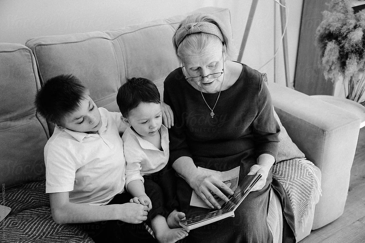 Grandmother reads a book to her grandson