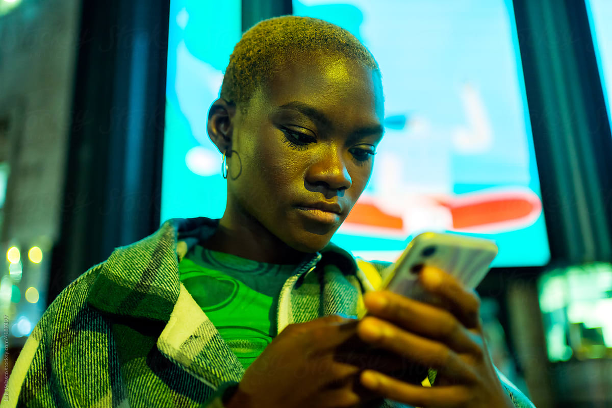 Modern Black Girl With Phone On The Street At Night.